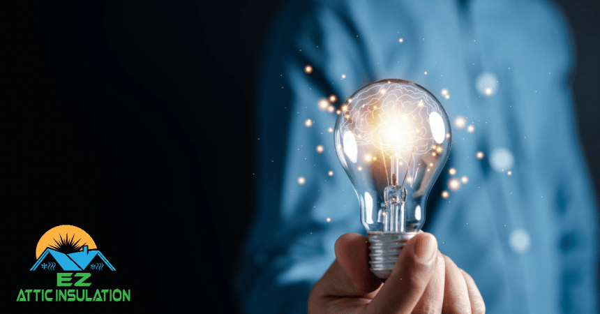 A man holding a lightbulb, symbolizing efforts to save energy in a home through means such as insullation installation.