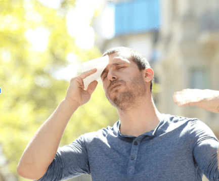 a man experiencing a heat wave due to bad insulation