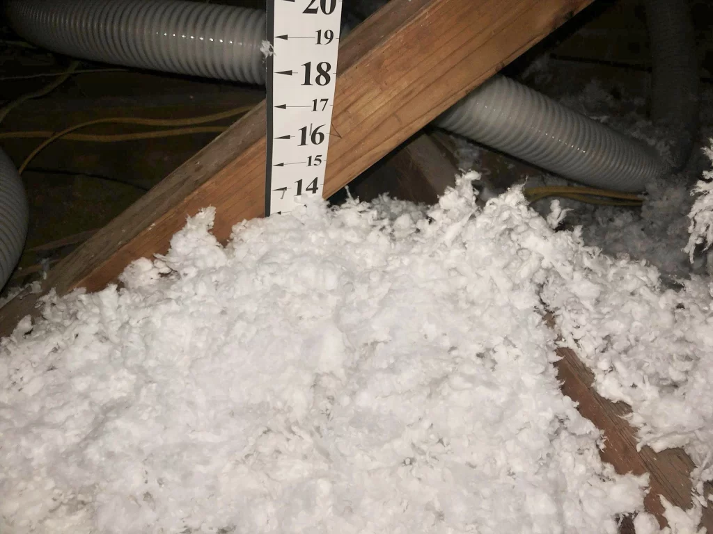 showing the depth of attic insulation in a completed job