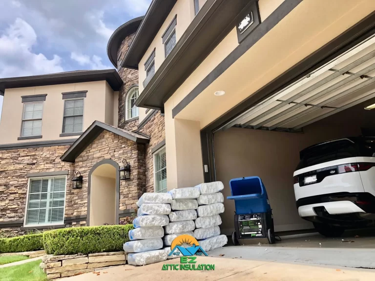 a residential home's garage with blow in fiberglass insulation next to the blow-in insulation machine