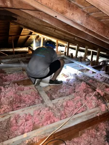 a ez attic insulation worker removing old insulation