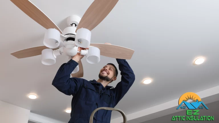 EZ Attic crewmember showcasing proper fan positioning for best indoor temperature.