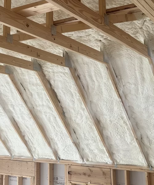 White Spray Foam Installed in an Attic to Insulate home from hot and cold temperatures.