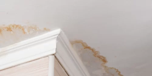 Signs of water damage on the ceiling, which is a common sign of poor insulation in an attic.