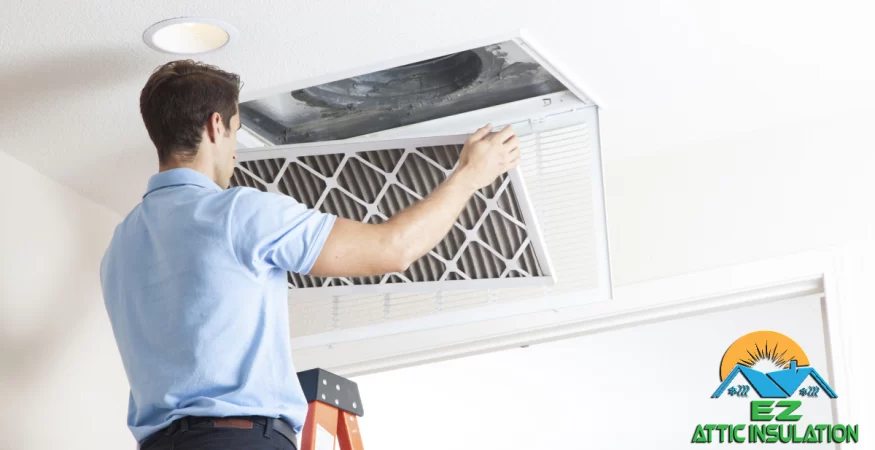 Man checking HVAC system in home by inspecting air ducts and air filter.