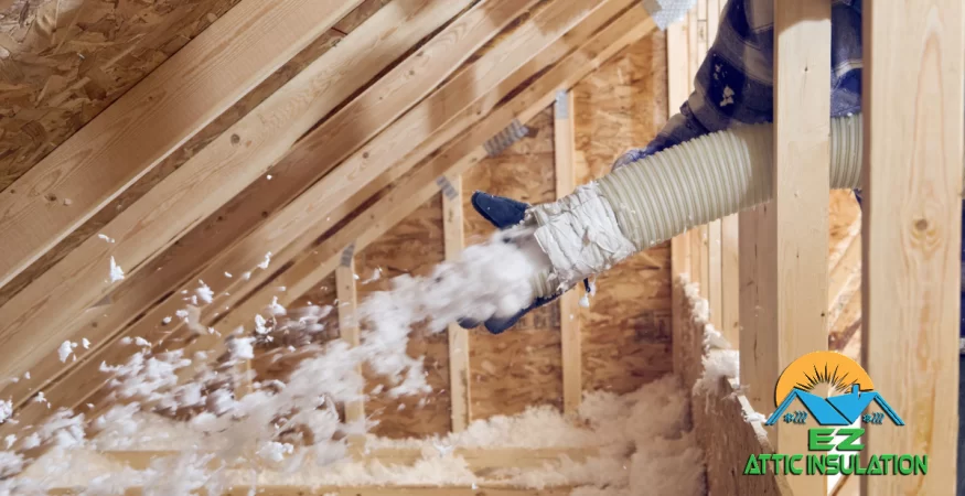 Attic insulation expert installing blow-in fiberglass insulation.