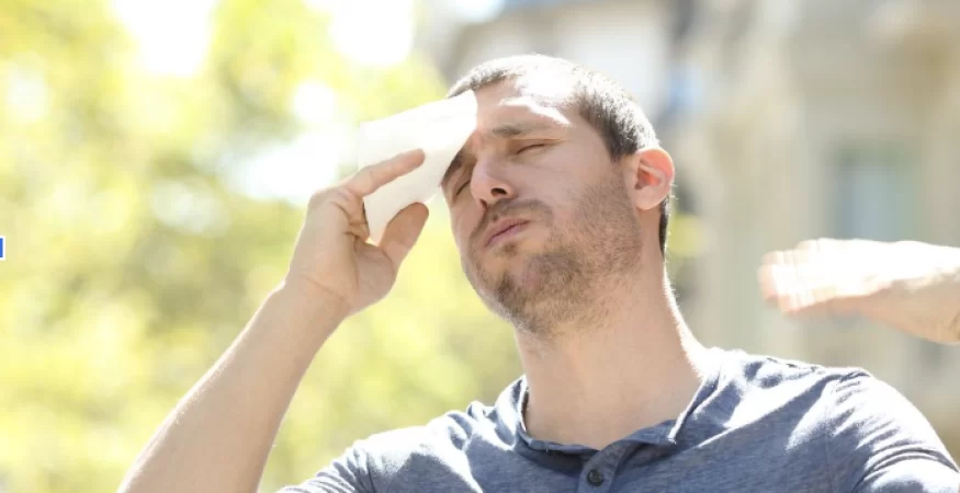 a man experiencing a heat wave due to bad insulation