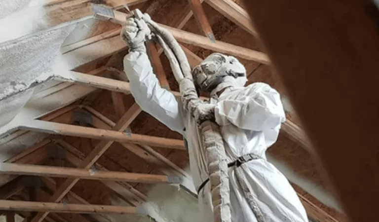 EZ Attic Insulation Expert actively installing new spray foam installation into a Houston attic.